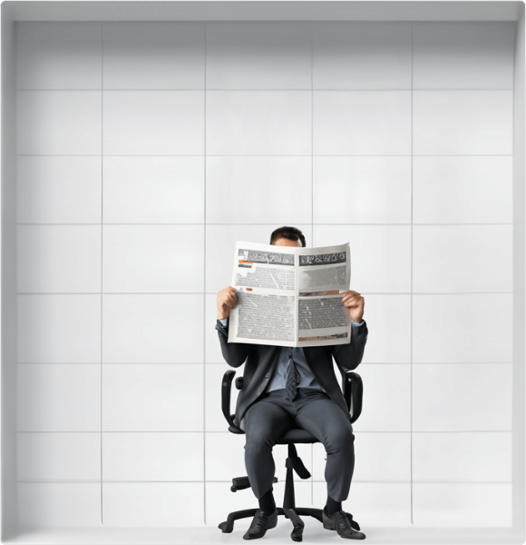 man holding a newspaper while sitting on a chair
